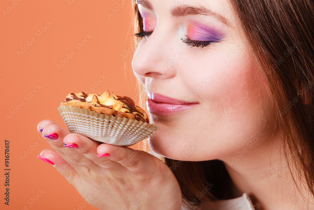 woman closed eyes holds cake in hand woman closed eyes holds cake in hand