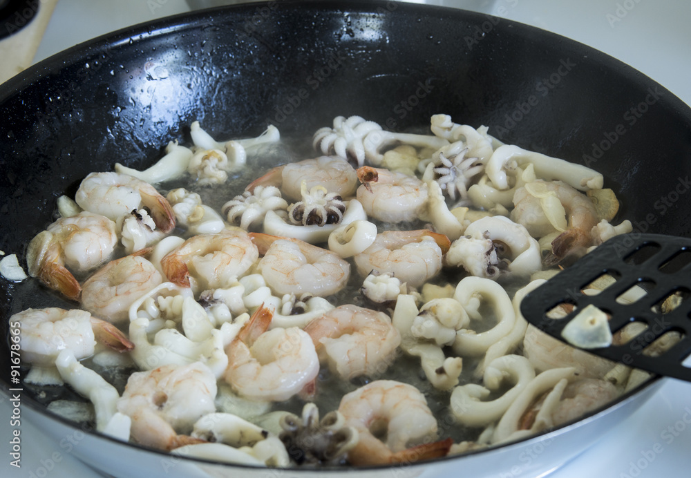 fried seafood in a frying pan fried seafood in a frying pan
