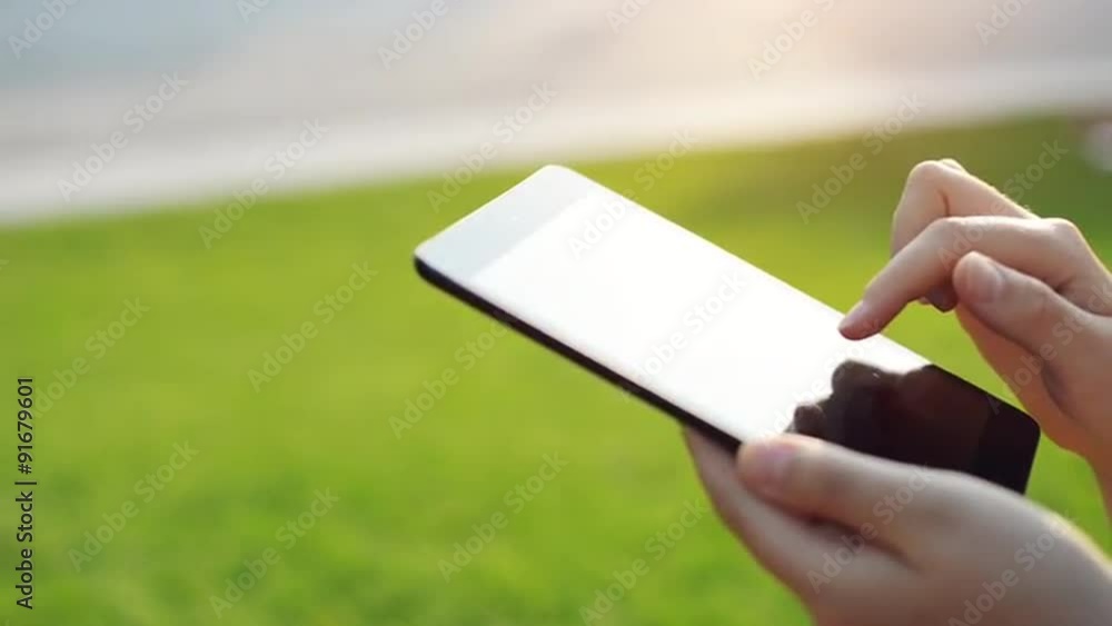 Close-up womans hands using digital tablet computer touchscreen Close-up womans hands using digital tablet computer touchscreen
