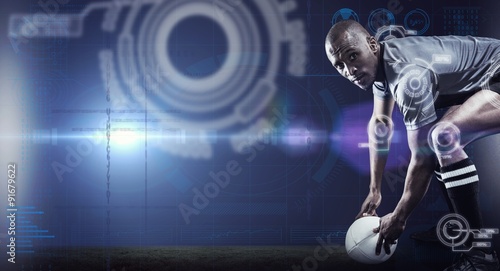 Composite image of portrait of rugby player holding ball