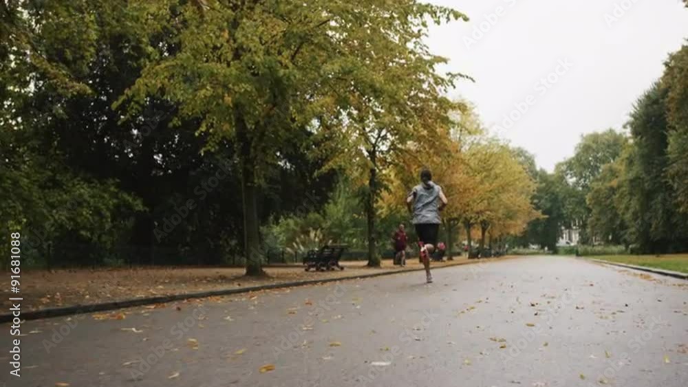 Runner woman running in park exercising outdoors fitness tracker wearable technology Runner woman running in park exercising outdoors fitness tracker wearable technology