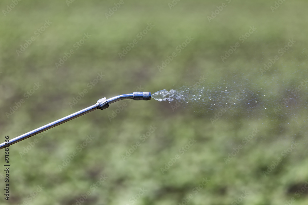 Close Up of a Crop Sprayer, nozzle spraying fertilizer on crop Close Up of a Crop Sprayer, nozzle spraying fertilizer on crop