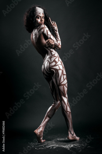 Gorgeous and sensual african model body covered with painted pol