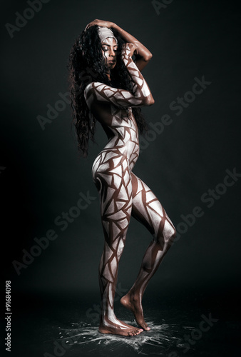 Beautiful african model body covered with painted polygons © patronestaff