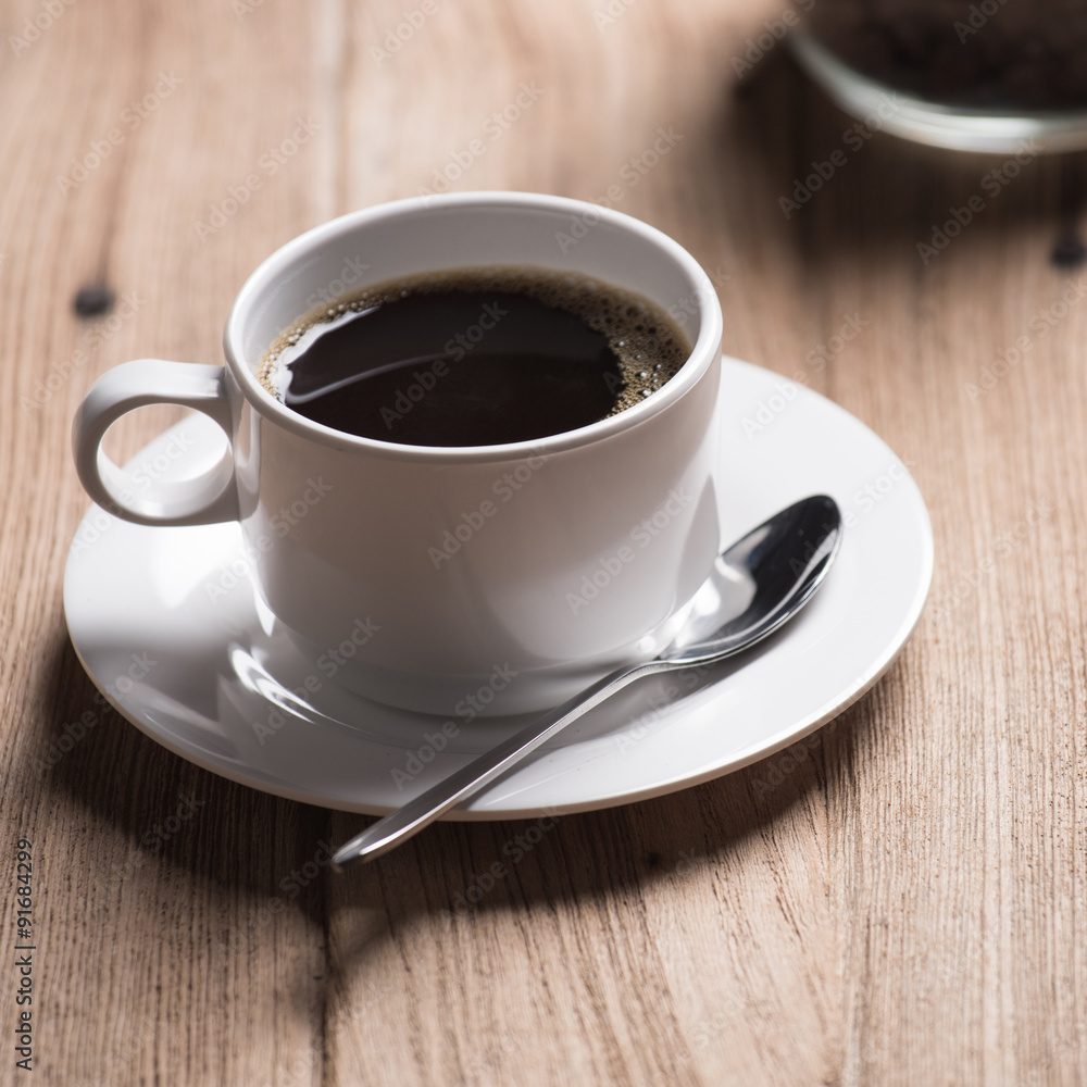 Coffee cup and saucer on a wooden table. Coffee cup and saucer on a wooden table.