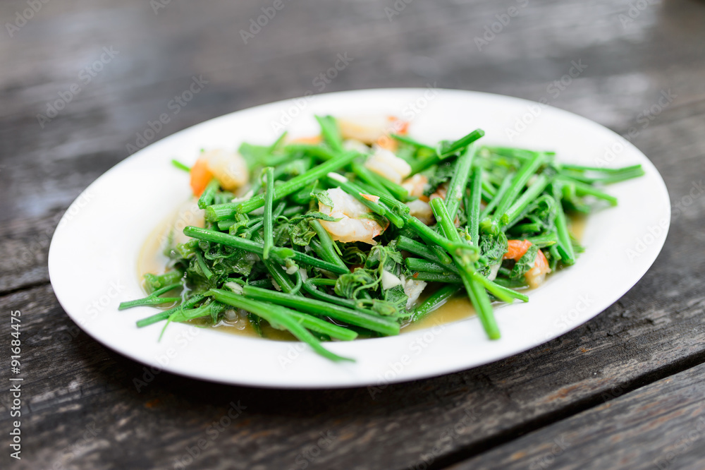 Fried bitter gourd leaf with oyster sauce , Thai style food Fried bitter gourd leaf with oyster sauce , Thai style food