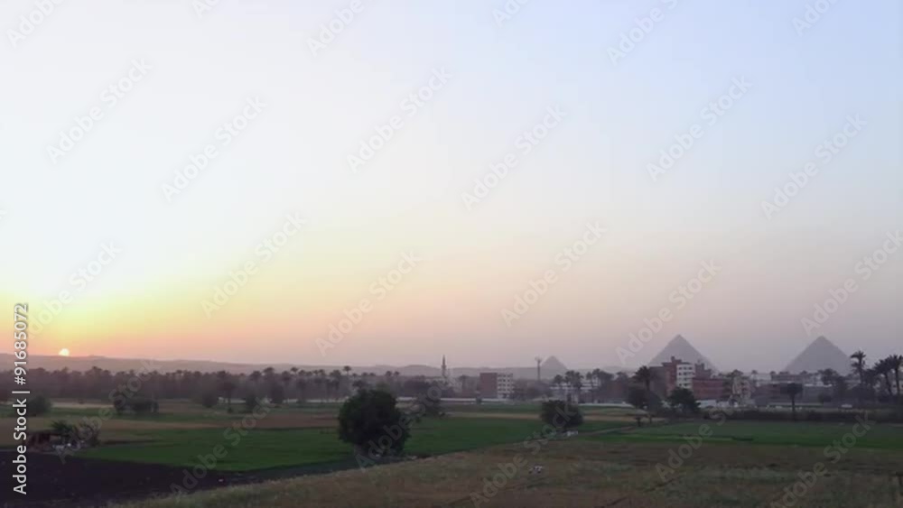 The pyramids of Egypt are seen at a distance at sunset. The pyramids of Egypt are seen at a distance at sunset.