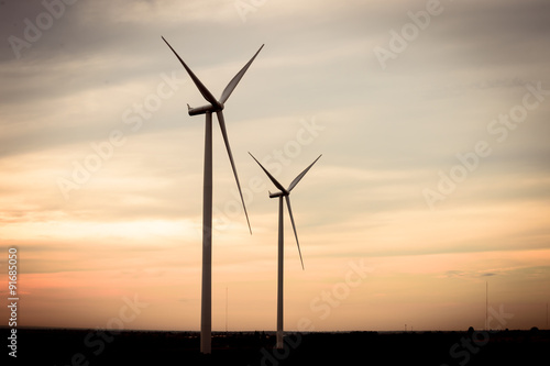 beautiful landscape image with Windturbine farm at the sunset