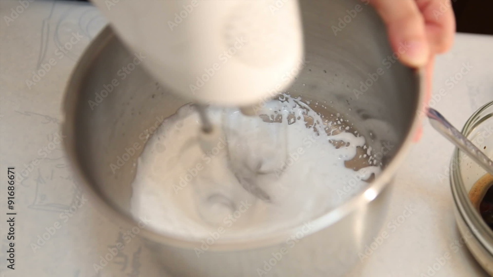 Video of electric mixer whipping cream from liquid milk Video of electric mixer whipping cream from liquid milk