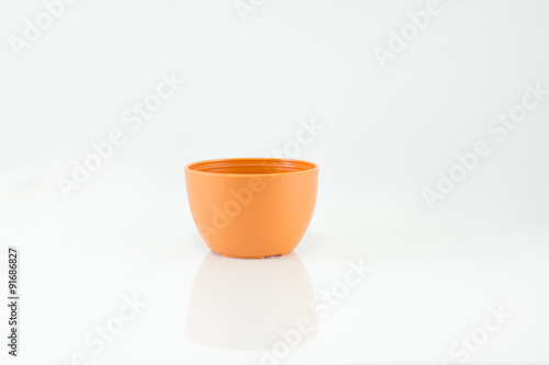 Small plastic potted plants on white background