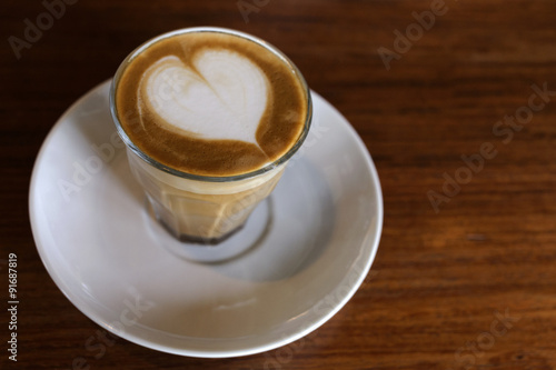 heart drawing on latte art coffee on wood table background