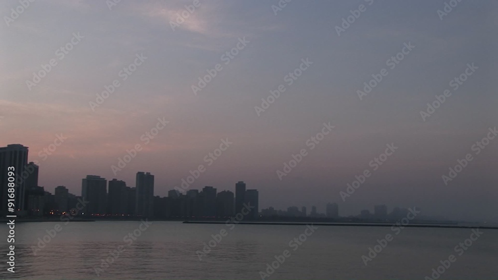 Slow pan-left across Chicago skyline during golden-hour from Lake Michigan. Slow pan-left across Chicago skyline during golden-hour from Lake Michigan.