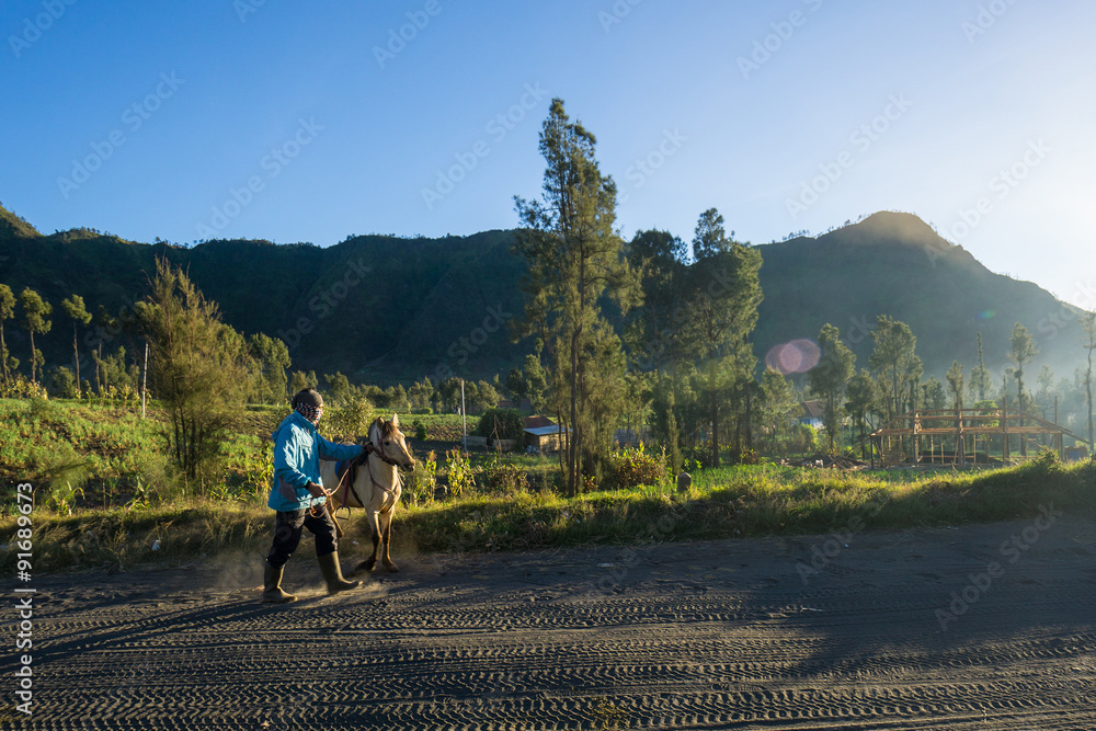 Fototapeta premium Cemoro Lawang during Sunrise, blue sky with orange and yellow colour