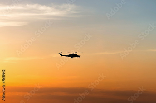 silhouette of the helicopter at sunset