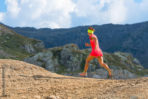 Female athlete runs in the mountains