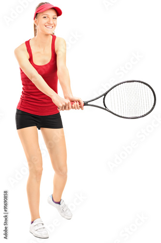 Female tennis player swinging a racquet