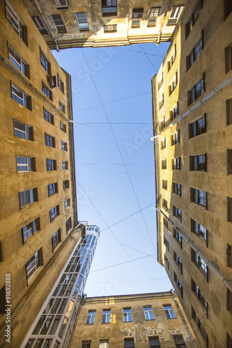 Yard-well the view from the bottom up, the traditional architecture of old St. Petersburg, Russia.