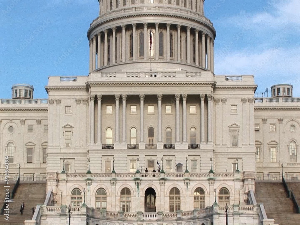 The camera pans up the U.S. Capitol building in Washington, DC from ground level to its landmark rotunda and dome. The camera pans up the U.S. Capitol building in Washington, DC from ground level to its landmark rotunda and dome.