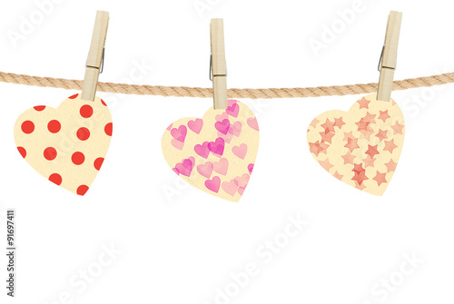 Bright hearts hanging on rope on wooden background