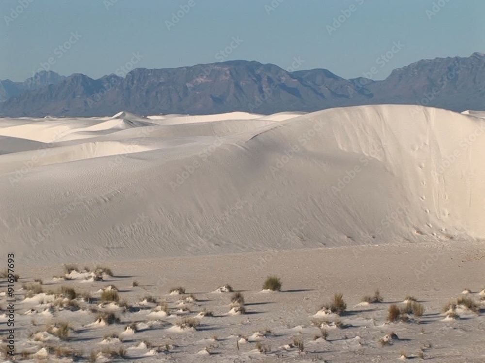 Pan-left of distant mountains and sand dunes at White Sands National Monument in New Mexico. Pan-left of distant mountains and sand dunes at White Sands National Monument in New Mexico.