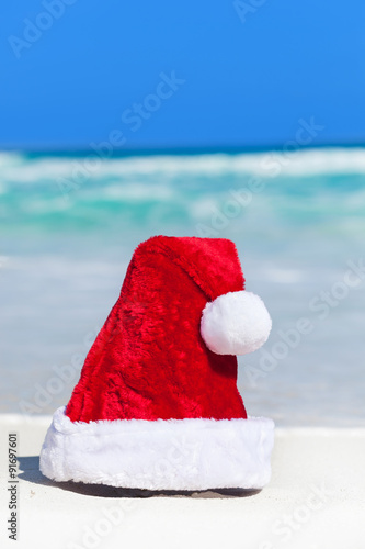 Santa helper hat on white sandy beach