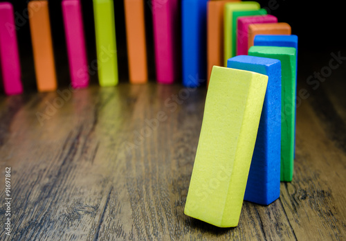 Fotografie The domino effect of colorful wooden blocks, Selective focus
