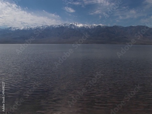 Long-shot of the Badwater Lake and Owlshead Mountains in Death Valley National Park. photo