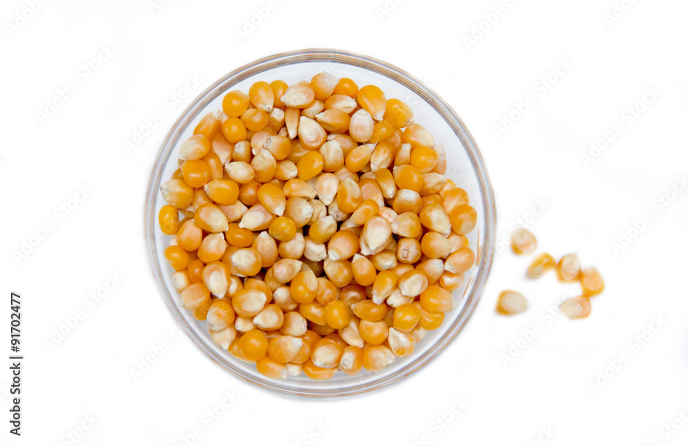 Bowl of dried corn kernels on a white background seen from above Bowl of dried corn kernels on a white background seen from above
