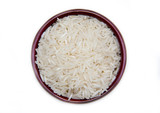 Bowl with uncooked rice on a white background seen from above