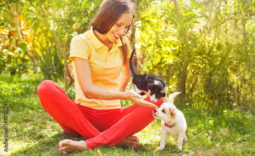 Photography woman playing with her can and dog outdoors