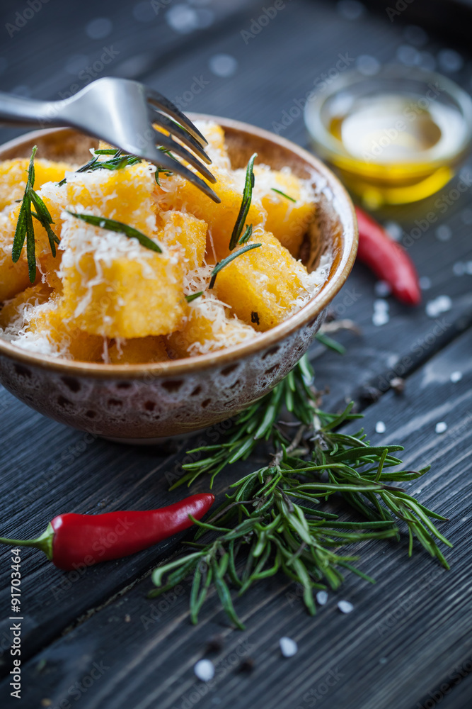 Crunchy croutons in bowl with rosemary