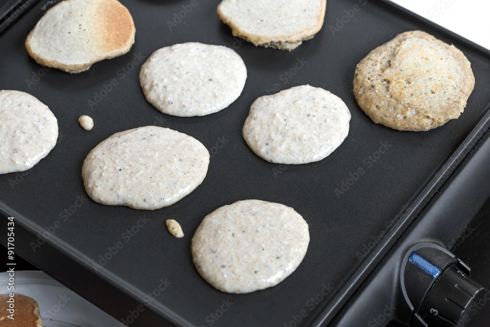 Oat pancakes cooking on electric barbecue Oat pancakes cooking on electric barbecue