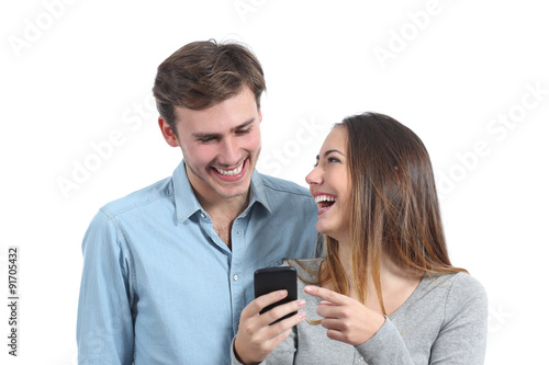 Happy friends laughing and watching a smart phone © Antonioguillem