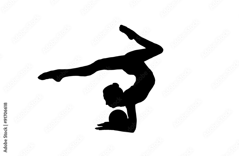 silhouette Flexible young gymnast doing exercises with a ball on silhouette Flexible young gymnast doing exercises with a ball on