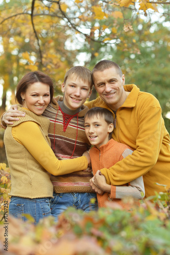 Happy family in autumn forest