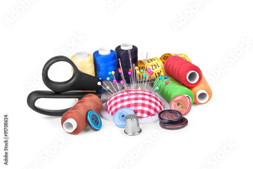 Sewing accessories: scissors, measuring tape, thimbles, colorful
