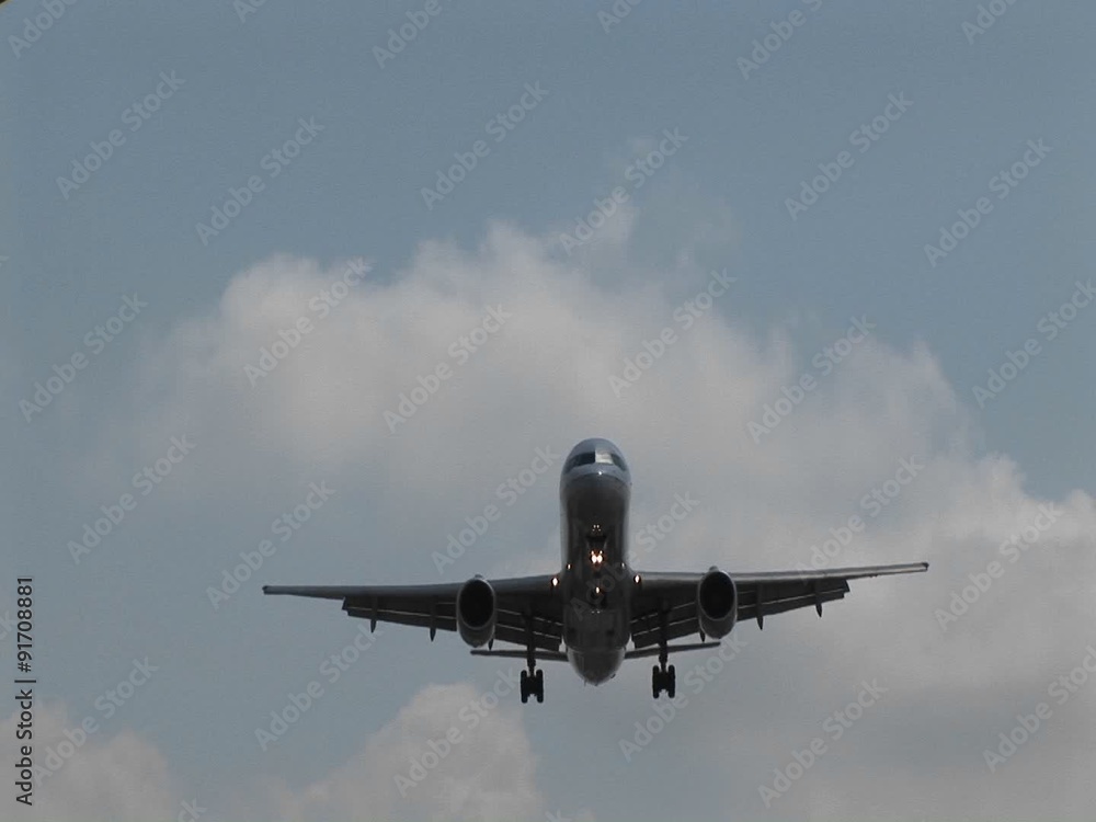 A jet airplane flying overhead. A jet airplane flying overhead.
