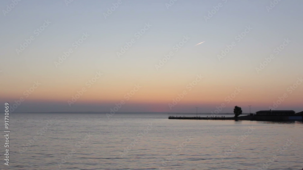 Sun over the water and wharf Sun over the water and wharf