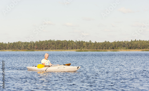 Man is driving kayak in water