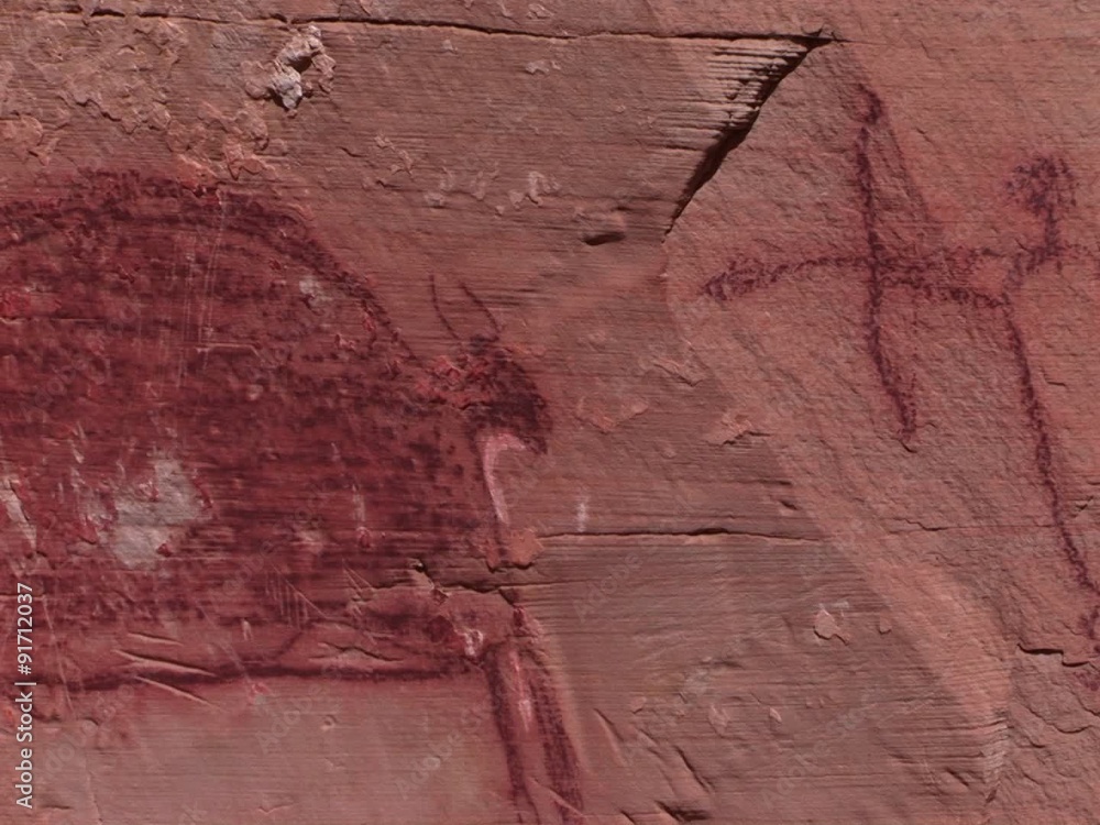A slow pan across mysterious petroglyphs in the Southwest desert of the USA showing early man killing or hunting with a bow and arrow. A slow pan across mysterious petroglyphs in the Southwest desert of the USA showing early man killing or hunting with a bow and arrow.