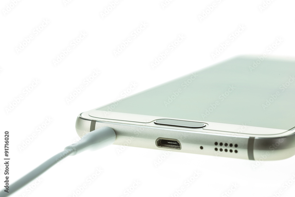 Macro Smartphone connect with headsets isolated on white Macro Smartphone connect with headsets isolated on white