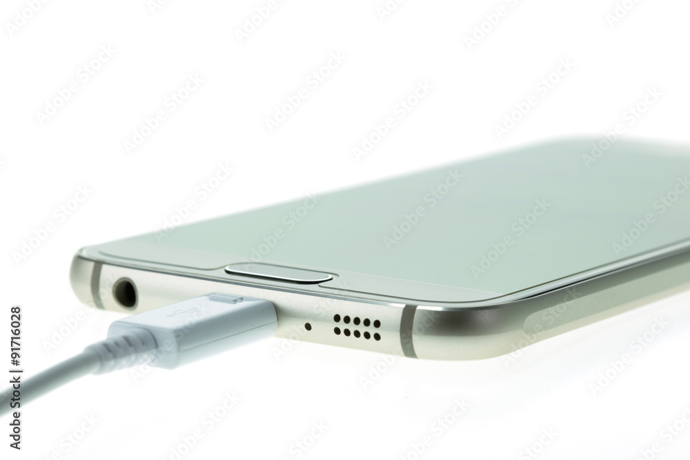 Macro Smartphone connect with charger isolated on white Macro Smartphone connect with charger isolated on white
