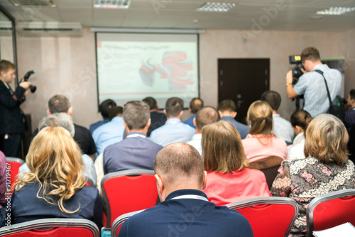 Business Conference and Presentation. The audience listens to the acting in a conference hall