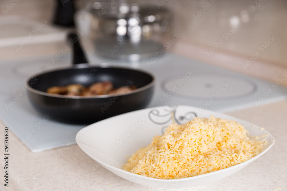 Freshly grated cheddar cheese in a bowl Freshly grated cheddar cheese in a bowl