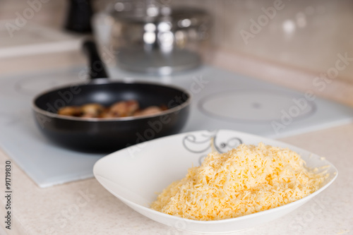 Freshly grated cheddar cheese in a bowl