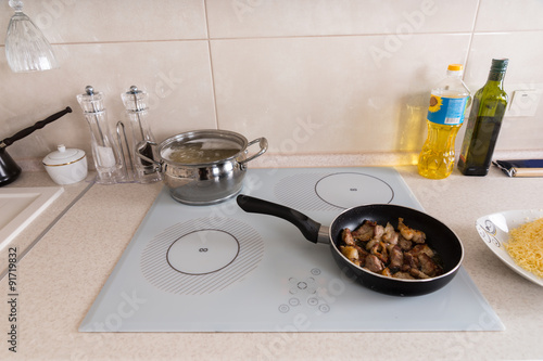 Cooking Meat and Pasta for Dinner on Stove Top