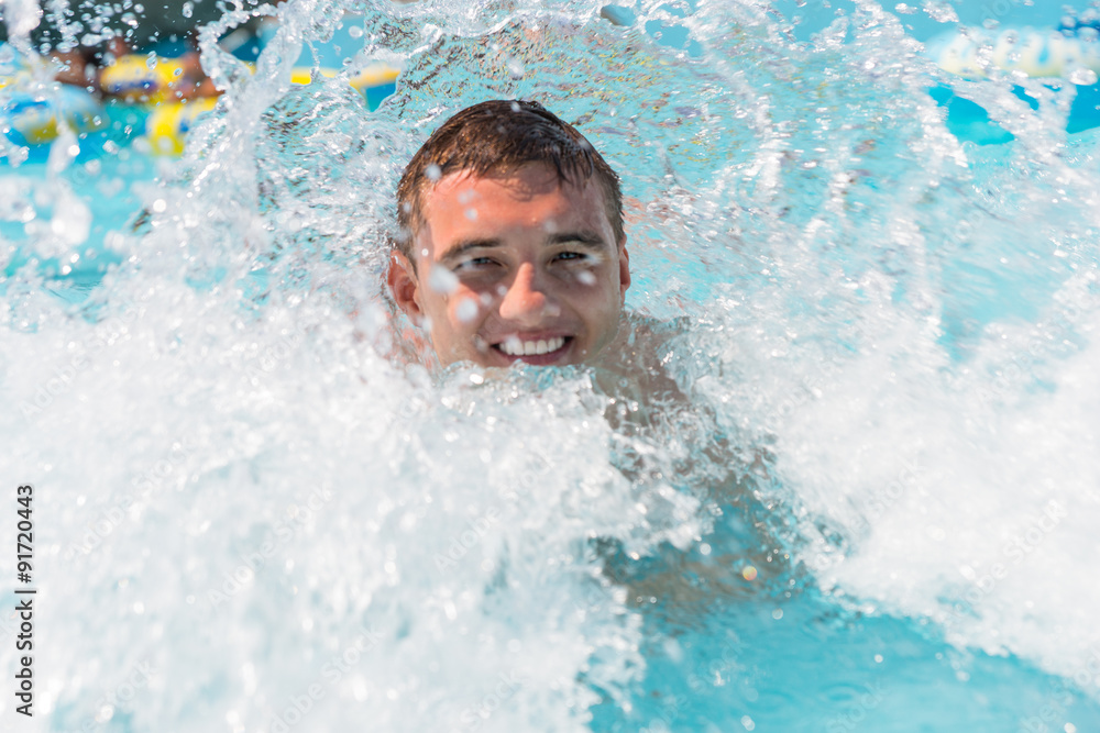 Young Man Enjoying Waves in Outdoor Wave Pool