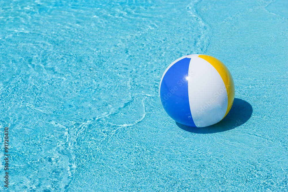 Inflatable Beach Ball Floating at Edge of Pool