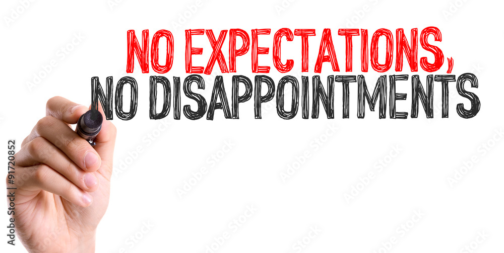 Hand with marker writing: No Expectations, No Disappointments Hand with marker writing: No Expectations, No Disappointments