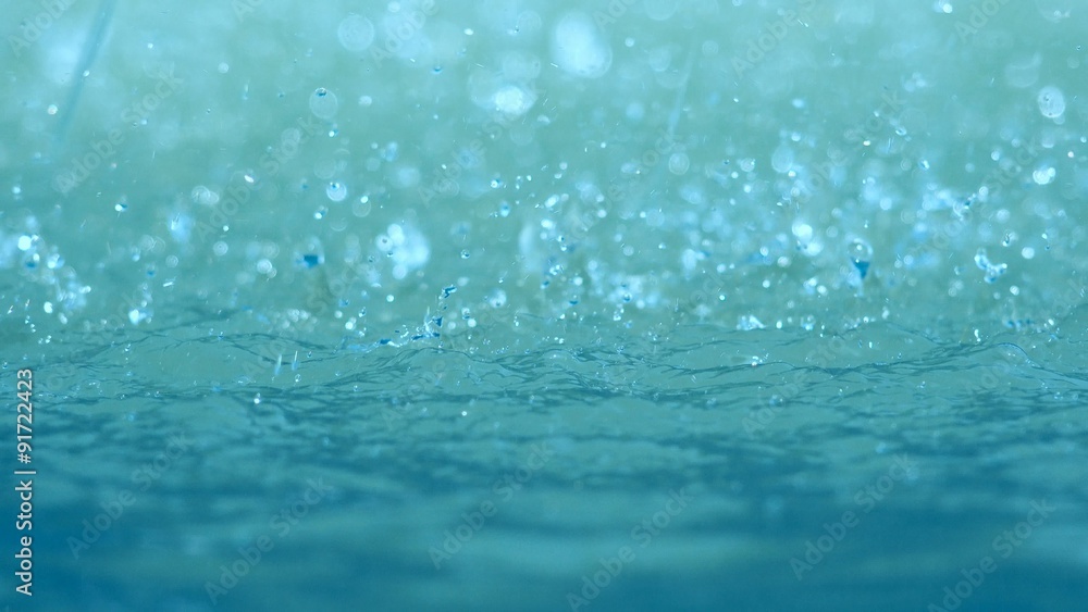 Water drops splashing pool surface, abstract motion background Water drops splashing pool surface, abstract motion background